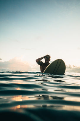 Man pondering  life on a Surfboard